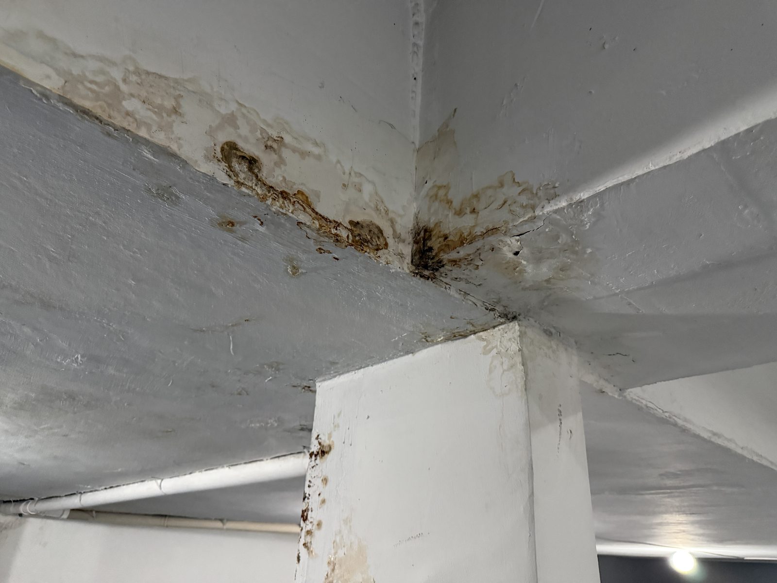 Sinais de umidade em laje, viga e pilar de garagem registrados em vistoria cautelar